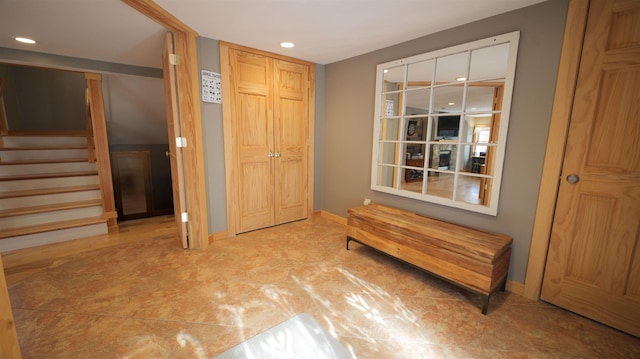 interior space featuring recessed lighting, baseboards, and stairs