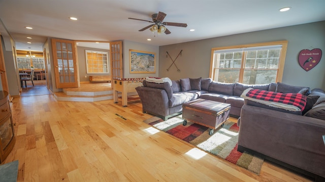 living area with recessed lighting, light wood-type flooring, and ceiling fan