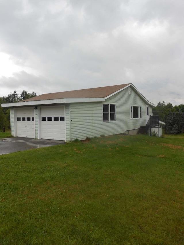 view of property exterior featuring a yard and a garage