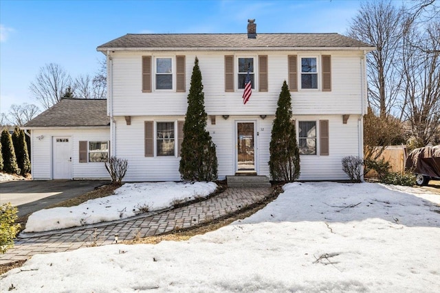 colonial inspired home featuring a chimney and fence