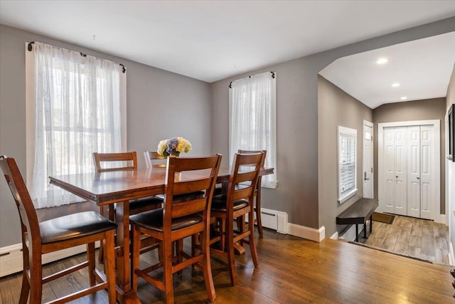 dining room with recessed lighting, a baseboard radiator, baseboards, and wood finished floors