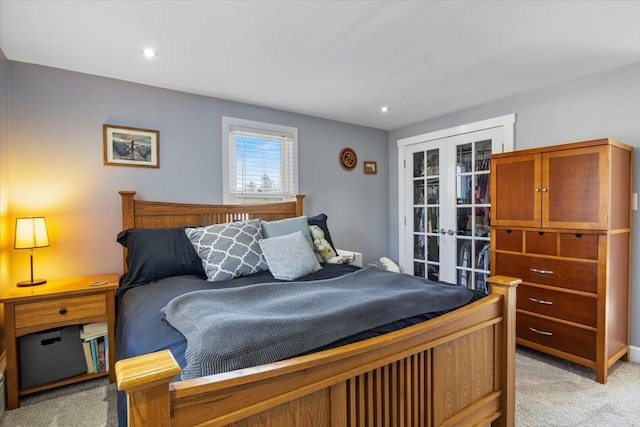 bedroom featuring recessed lighting, french doors, and light colored carpet