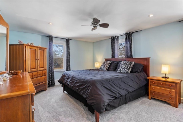 bedroom featuring light carpet, recessed lighting, a baseboard heating unit, and ceiling fan