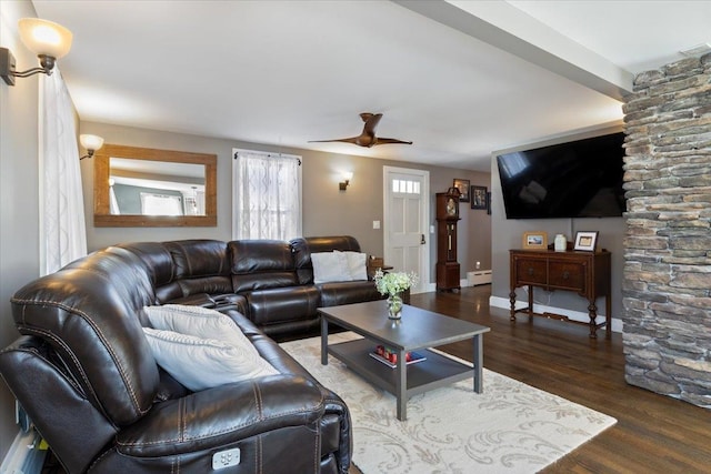 living area with ceiling fan, a baseboard radiator, baseboards, and wood finished floors