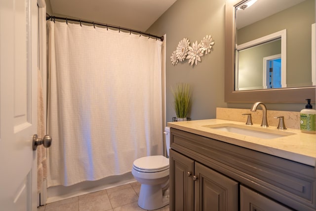 bathroom with tile patterned floors, shower / bathtub combination with curtain, toilet, and vanity