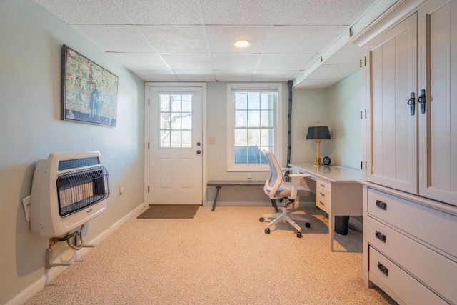 office featuring heating unit, baseboards, and a drop ceiling