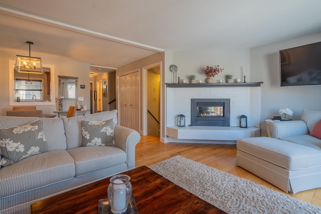 living area featuring a tile fireplace and wood finished floors