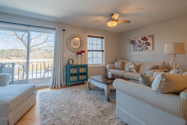 living room featuring a ceiling fan and wood finished floors