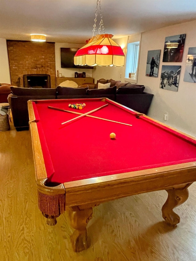 game room with a brick fireplace and billiards