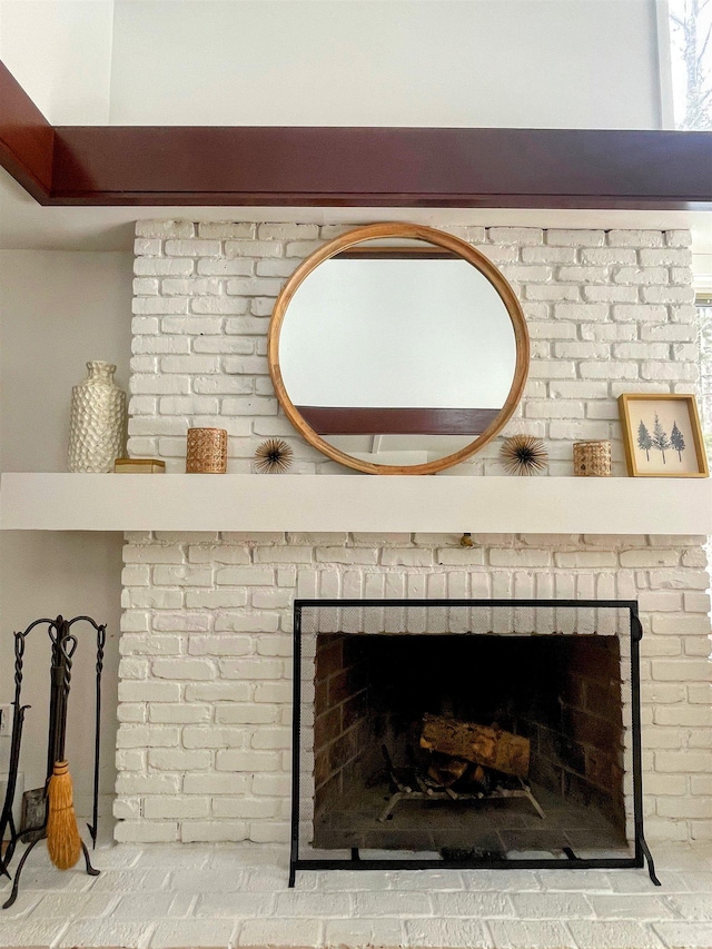 interior details featuring a brick fireplace