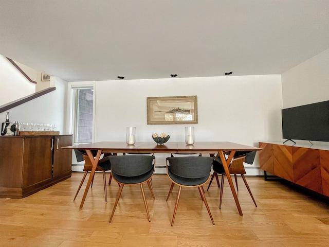 dining space featuring light wood finished floors