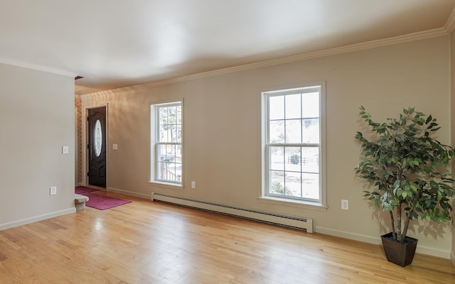 empty room with a baseboard radiator, baseboards, light wood-style floors, and crown molding