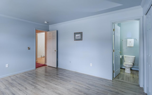 unfurnished bedroom featuring baseboards, wood finished floors, and ornamental molding