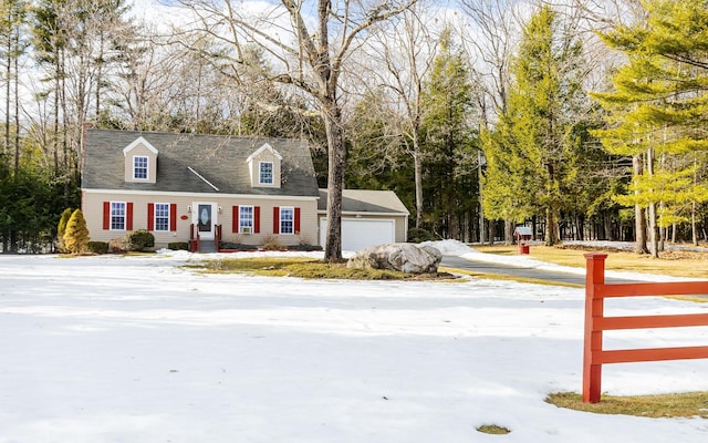 cape cod house featuring an attached garage