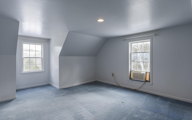 additional living space featuring carpet flooring, cooling unit, baseboards, and lofted ceiling