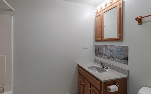 bathroom featuring a shower, toilet, and vanity