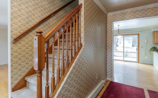 staircase featuring baseboards, wood finished floors, ornamental molding, and wallpapered walls