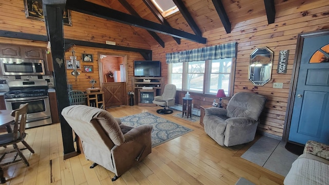 living area with beam ceiling, wooden walls, light wood finished floors, and a skylight