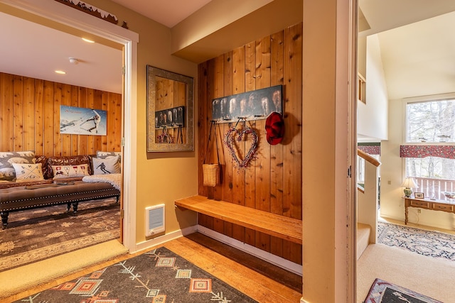 mudroom featuring visible vents and wood walls