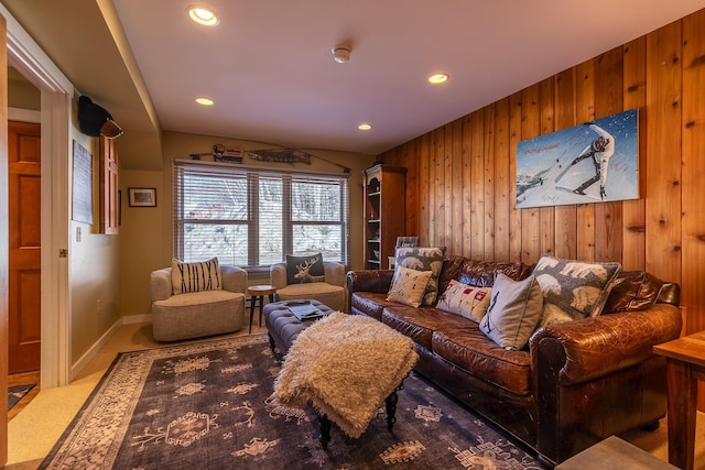 carpeted living room with recessed lighting, wood walls, and baseboards