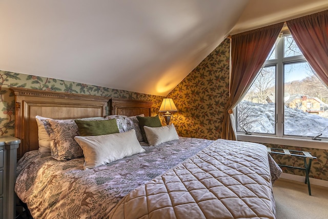 bedroom featuring wallpapered walls, lofted ceiling, and carpet floors