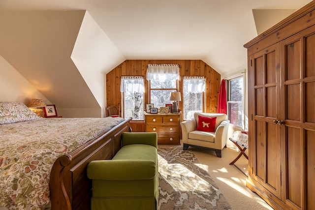 bedroom featuring vaulted ceiling, light colored carpet, and multiple windows