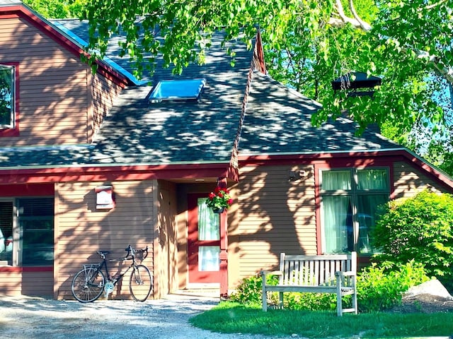 exterior space with roof with shingles