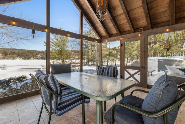 sunroom / solarium with a wealth of natural light, wood ceiling, and lofted ceiling with beams