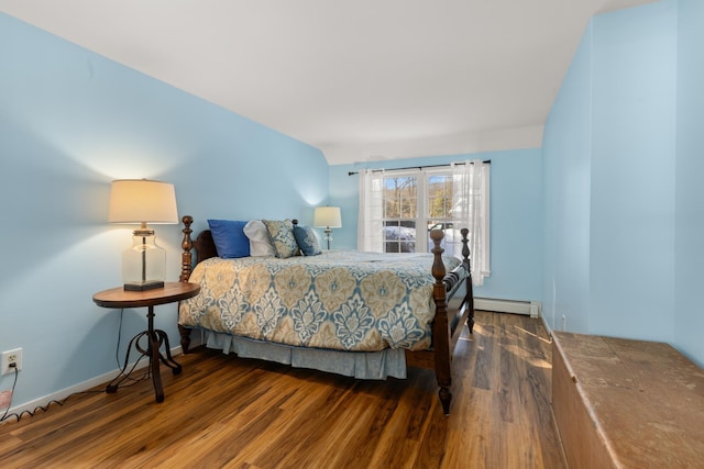 bedroom featuring wood finished floors, baseboards, and baseboard heating