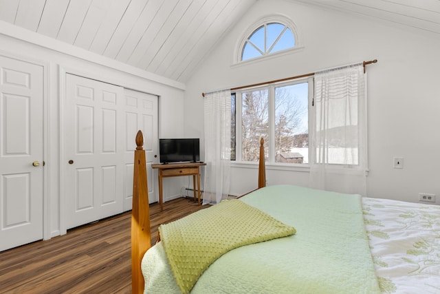 bedroom with wood finished floors, high vaulted ceiling, a baseboard radiator, a closet, and wooden ceiling