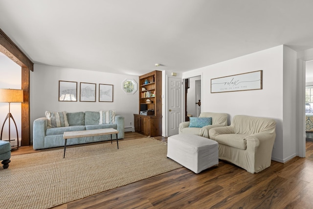 living area with dark wood-type flooring and a baseboard radiator