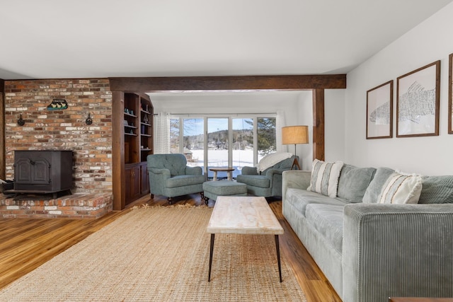 living area featuring a wood stove and wood finished floors