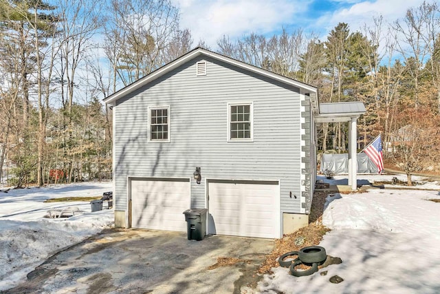 view of home's exterior with driveway and a garage