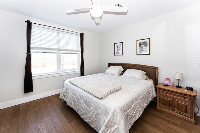 bedroom featuring visible vents, a ceiling fan, baseboards, and wood-type flooring