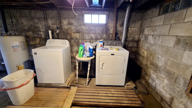 laundry area featuring separate washer and dryer, water heater, and laundry area