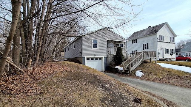 view of front of property featuring aphalt driveway and a garage