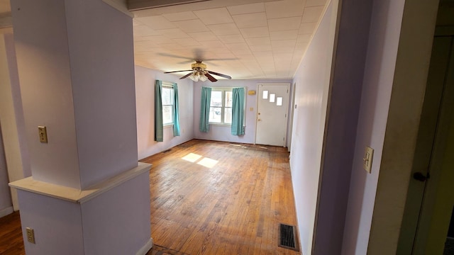 interior space featuring hardwood / wood-style flooring, a ceiling fan, and visible vents