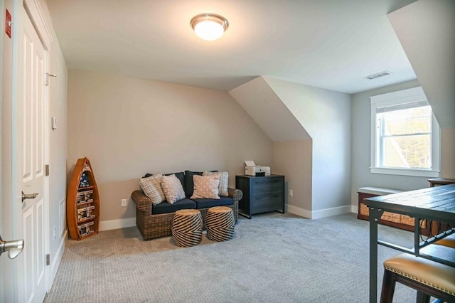 interior space featuring visible vents, baseboards, lofted ceiling, and carpet flooring