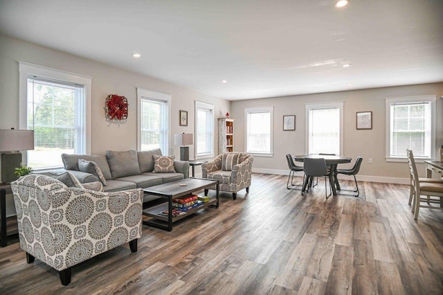 living room with recessed lighting, baseboards, and wood finished floors