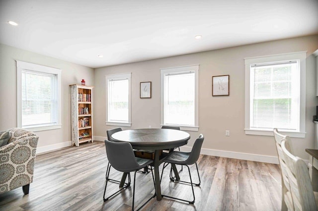 dining space featuring recessed lighting, wood finished floors, and baseboards