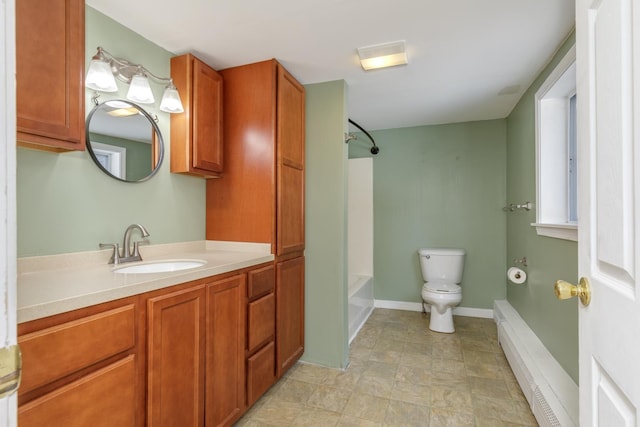 bathroom with vanity, baseboards, a baseboard radiator, toilet, and shower / bathtub combination