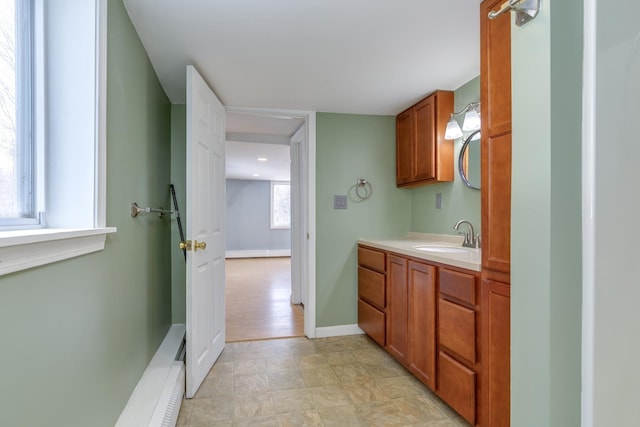 bathroom with baseboards and vanity