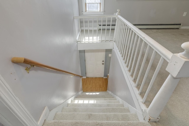 stairs featuring baseboards and baseboard heating