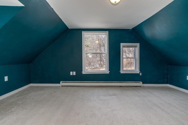 bonus room featuring lofted ceiling, baseboards, carpet floors, and a baseboard radiator