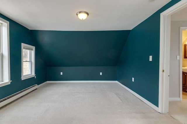 bonus room with baseboard heating, lofted ceiling, baseboards, and carpet floors