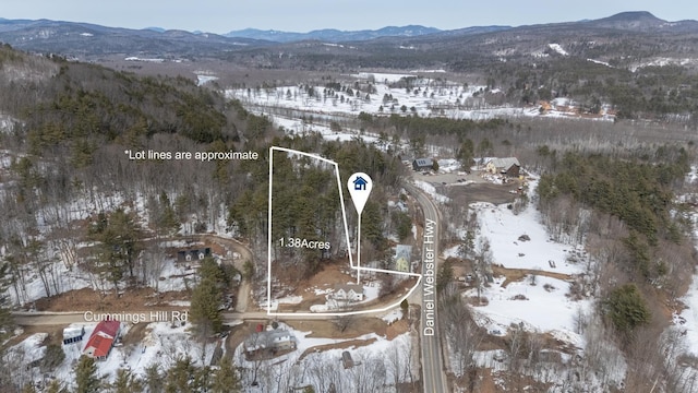 snowy aerial view featuring a mountain view