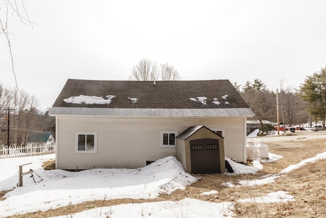 exterior space featuring a storage shed, fence, and an outdoor structure