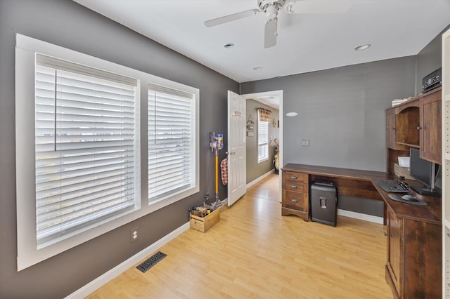 office space with ceiling fan, wood finished floors, visible vents, and baseboards