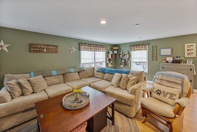 living room featuring recessed lighting, baseboards, and light wood finished floors