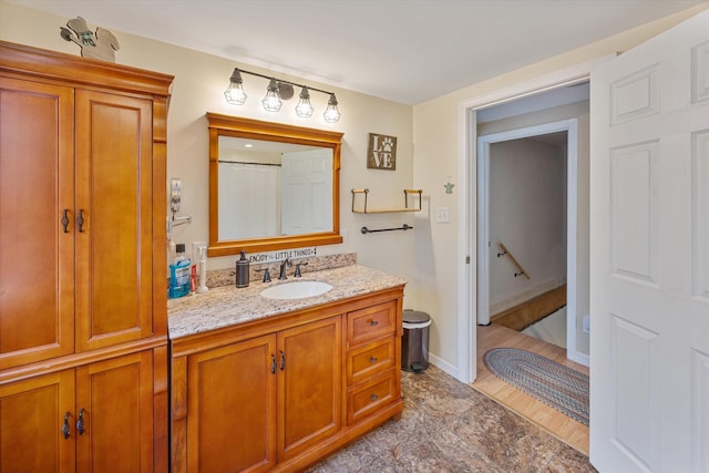 bathroom with vanity and baseboards